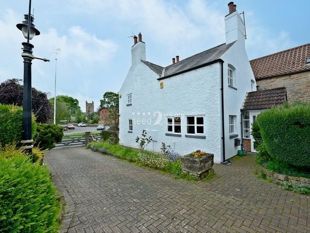 At the side of the Main Street cottage is this large driveway that provides lots of space for off-street parking.