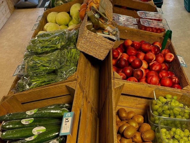 The store is well-stocked with fresh produce and features a spacious, accessible, and vibrant layout.