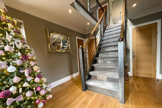 As you step inside the entrance hall, you are immediately struck by this extraordinary staircase, made of British steel and oak, that is the central point of the three-storey home. The hall also boasts solid oak flooring, a vertical radiator and spotlights, and gives access to a built-in boot room.