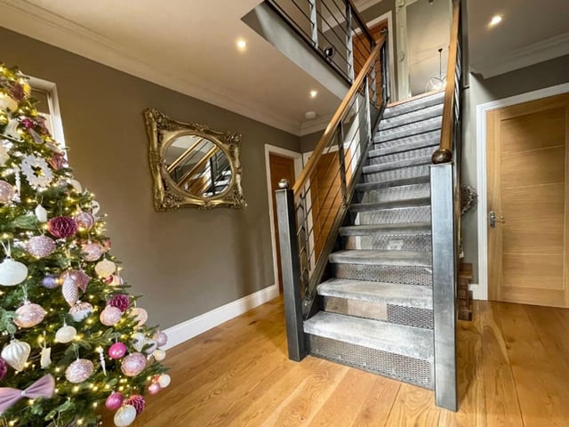 As you step inside the entrance hall, you are immediately struck by this extraordinary staircase, made of British steel and oak, that is the central point of the three-storey home. The hall also boasts solid oak flooring, a vertical radiator and spotlights, and gives access to a built-in boot room.