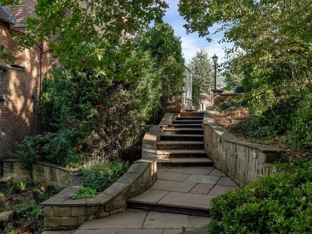 This charming walkway of steps, by a rockery space, leads to a sheltered and private lower-level garden at the back of the property.