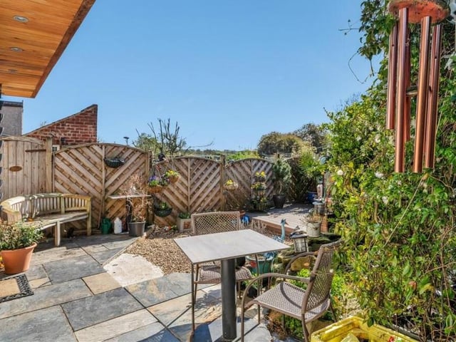 Another feature of the back garden is this flagstone patio area. Ideal for alfresco relaxation.