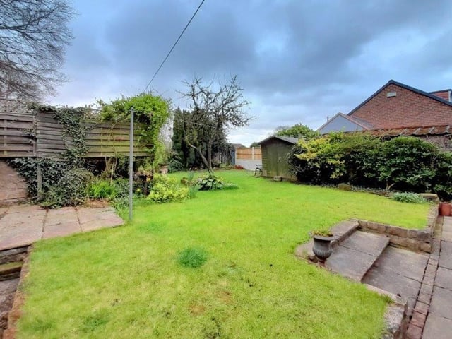 The back garden is a delightful space, with patio areas, lawn, steppings, shrubs, plants and trees.
