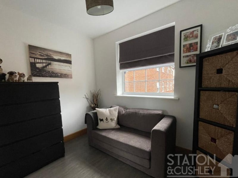 A bedroom that has multiple uses. Maybe it can be deployed as storage space or as a retreat for relaxation.