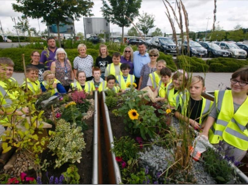 Members of Giltbrook Wildlife add a floral feature to the car park at the town's retail park.