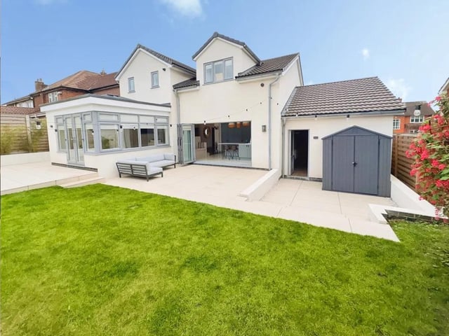 The rear garden has been professionally landscaped with multiple seating areas, a lawn, and raised beds-ideal for modern outdoor living and entertaining space.