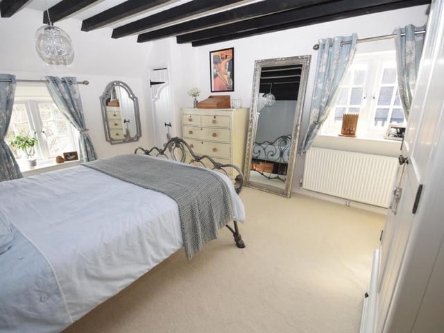 The principal bedroom on the first floor is a substantial size, and oozes charm, helped, of course, by the beamed ceiling. Windows at the front and side of the cottage allow lots of natural light to flow.