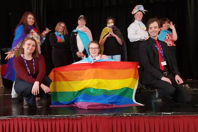 Proudly displaying the rainbow flag are students in Quarrydale Academy's LGBTQ+ support group, Ambassadors, and two members of staff, history teacher Beth Reid and teaching assistant Corey Eadson.