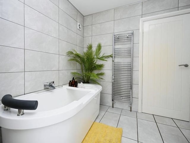 The family bathroom is a sparkling place. It is fitted with a bath, shower, wash basin with vanity unit, low-flush WC and heated towel-rail.