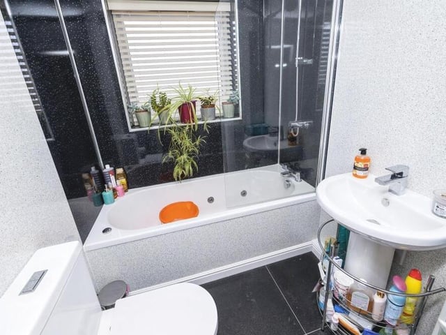 Also sitting on the first floor is this extra bathroom, containing Jacuzzi with overhead shower and glass door, wash basin and WC