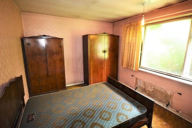This double bedroom has clearly seen better days. But on a positive note, it is bright and a decent size, with room for wardrobes.