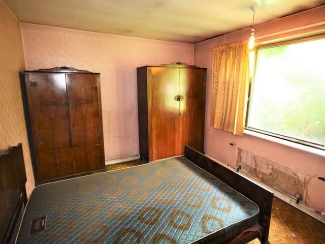 This double bedroom has clearly seen better days. But on a positive note, it is bright and a decent size, with room for wardrobes.