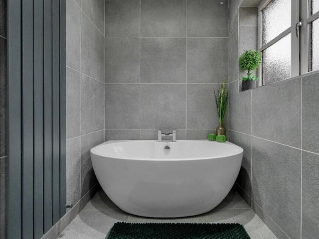 A close-up of the free-standing bath, with up-and-over chrome central mixer tap, in the family bathroom.