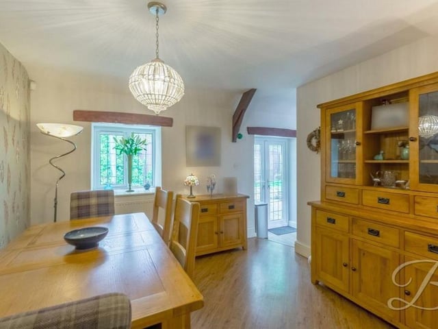 The pleasant and bright dining room from a different angle. In the background, you can see doors that lead out to the garden.