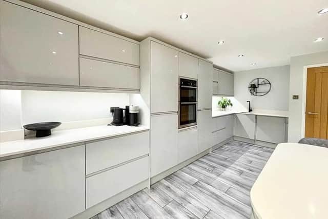 The show stopper kitchen boasts sleek and stylish kitchen units, integrated appliances, breakfast island with induction hob, cupboard space and a wine cooler