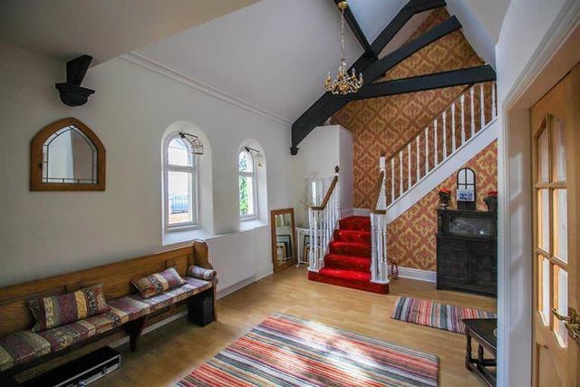 This beautiful entrance hallway includes an original church pew along the wall and provides access to the ground floor living areas as well as the first floor via the main staircase.