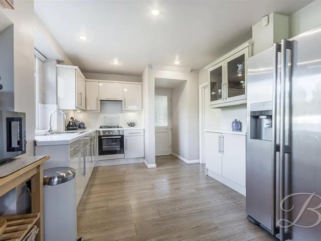 The kitchen is fitted with a neutral range of wall and base units incorporating drainer sink unit with complementary tiled splash backs. Integrated electric oven and gas hob. Stained glass window to side and window to rear elevation and central heating radiator.