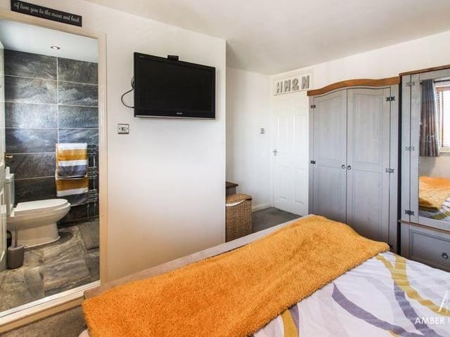 The master bedroom again, showing its access to the en suite. The flooring is carpeted and there is plenty of room for wardrobes and drawers.