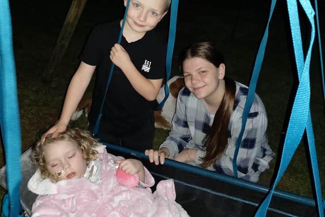 Chloe Askew, 5 enjoys her swing with brother Jensen Askew 6 and sister Ellie Cotterell 14.