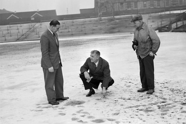 A snowy Tynecastle football pitch being examined by Tommy Walker, SFA Referee Jack Jeans and groundsman Matt Chalmers in 1963.