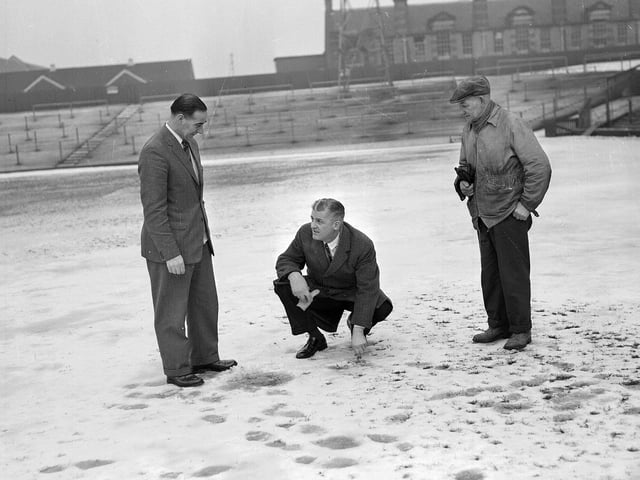 A snowy Tynecastle football pitch being examined by Tommy Walker, SFA Referee Jack Jeans and groundsman Matt Chalmers in 1963.