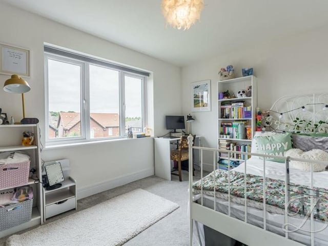 A bedroom at the £490,000-plus house that seems full of life. Like all five, it has a carpeted floor.