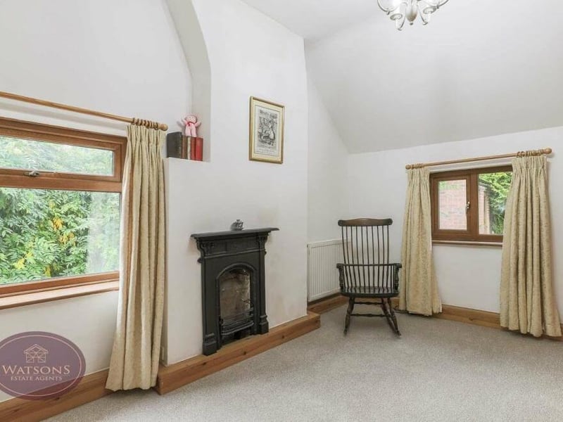 Character oozes from the corner of this bedroom. The windows overlook the rear and side of the house.