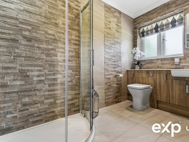 A statement bathroom, fitted with both a roll-top bath and a separate shower cubicle