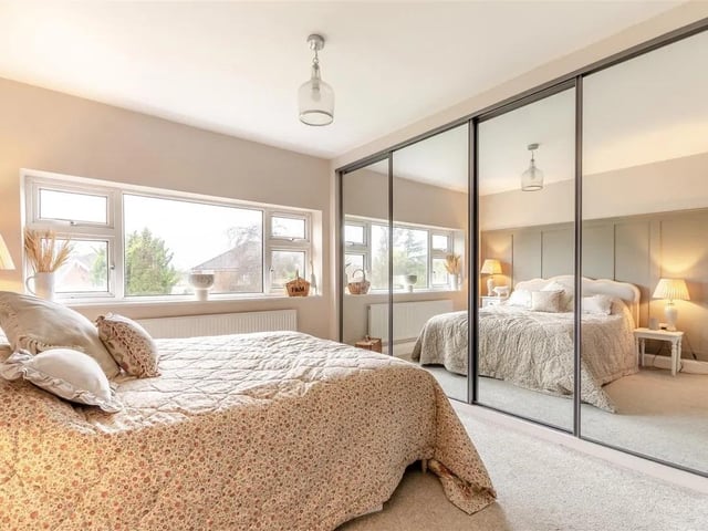 This double features extensive fitted wardrobes with hanging rails and shelving and mirror fronted doors.