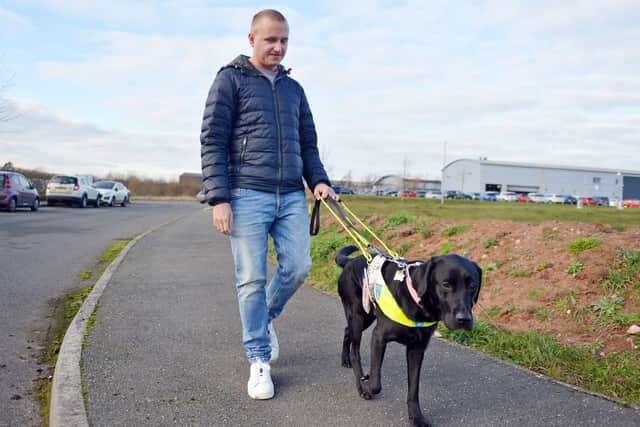 Nathan Edge enjoying a walk with his current guide dog, Abby.