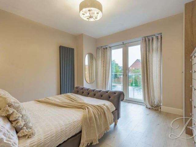 The standout feature of the main bedroom on the first floor is access on to a spacious balcony. The floor of the room is laminated, and there is space for cupboards or drawers.