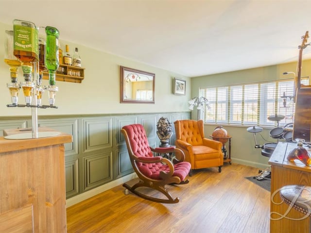The second and third bedrooms at the bungalow are currently being used for other things. This one is a space where you can relax, play or work, and the current owners have even installed a mini-bar. But it can easily be converted back into a double bedroom.