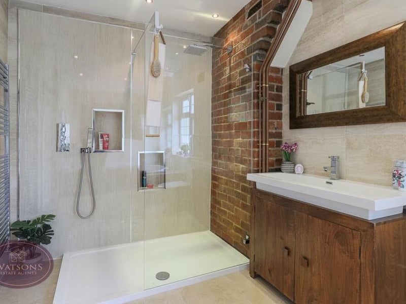 The family bathroom on the first floor is fabulous. A four-piece suite in white includes a walk-in shower cubicle with dual rainfall-effect shower, a vanity sink unit with storage and two chrome heated towel-rails.