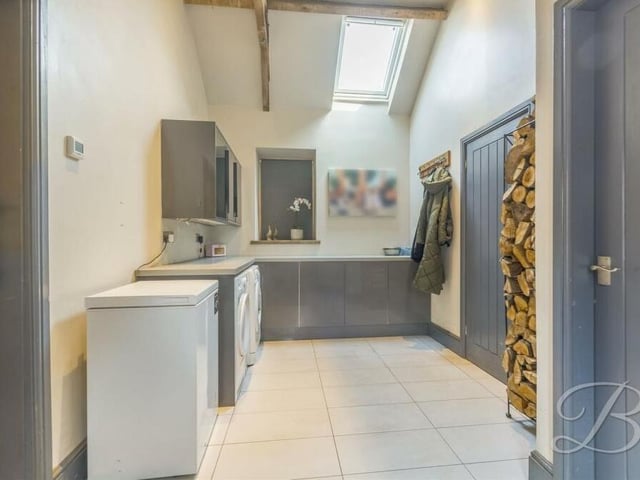 Not far from the kitchen is this useful utility room, which has space for a washing machine and tumble dryer.