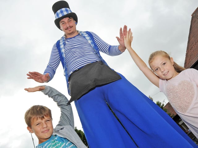 Kirkby Plaza Fun Day 2018 - pictured Mason Richards, 10 and his 9 year old sister, Poppy, from Kirkby, give high fives to Joker Entertainment's Blake Murray.