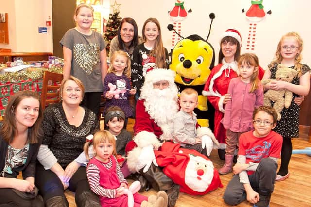 An example of a community event at Debenhams in Mansfield as winners of a Chad competition enjoy tea with Santa in 2012.