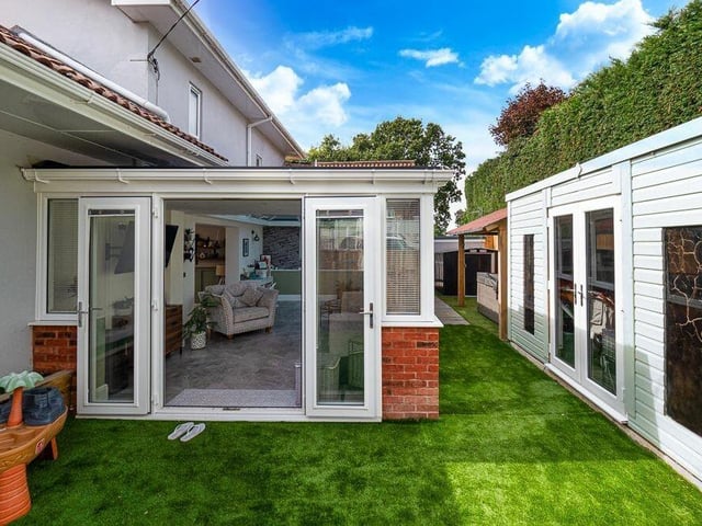 This photo shows the doors that open into the garden from the conservatory, with the bar and games room to the right.