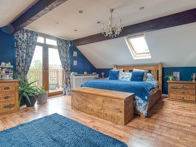 The master bedroom is a spectacular, spacious sight. The super king-sized bed sits close to double-glazed doors that lead to a balcony.