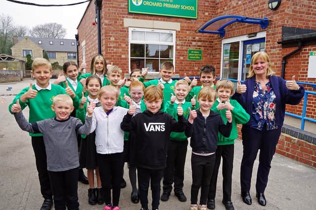 Thumbs up from head teacher Jane Chambers and several pupils after Orchard Primary School in Kirkby had been given a 'Good' rating by Ofsted inspectors.
