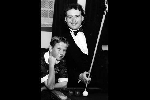 Jimmy White shows Ian Burton a trick or two during an exhibition at The Top Spot Snooker Club in Leigh Park, 1993. The News PP4529