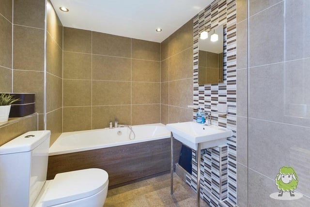 The family bathroom at the converted stables property can be found on the first floor.  A modern suite comprises a full-sized bath, shower, wash hand basin and WC, with attractive tiling and spotlights.