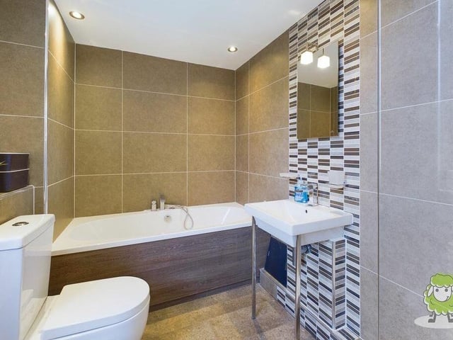 The family bathroom at the converted stables property can be found on the first floor. A modern suite comprises a full-sized bath, shower, wash hand basin and WC, with attractive tiling and spotlights.