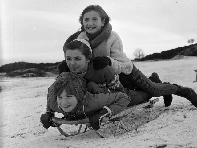 Three girls sledging on the Braid Hills in 1964.