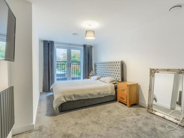 The first of the bedrooms we look at is the master, which is distinguished by a Juliet balcony that overlooks the back of the £575,000 property. It also boasts a carpeted floor and an air-conditioning unit, with access to an en suite bathroom.