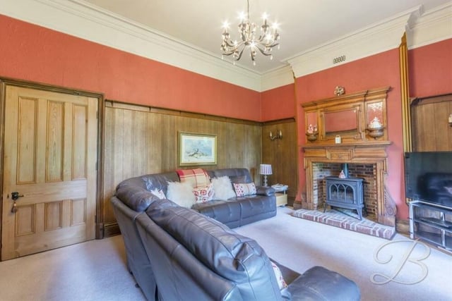 Another feature fireplace with gas stove takes the eye in the wonderful lounge. The room also boasts wooden panelling, fitted carpets and two windows to the side of the house.