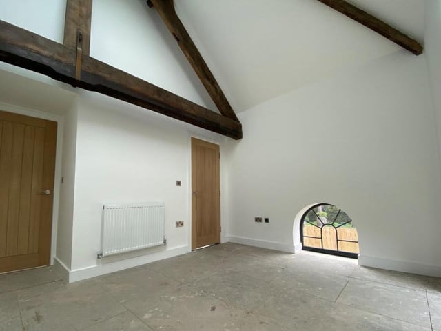 Note how the most has been made of original features, all given a contemporary twist. The wooden beams and half-height windows are from a different era, and yet the room has a modern feel.