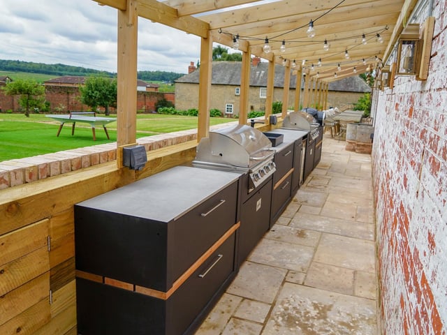 Cuckney House on the Welbeck Estate features a vast outdoor kitchen terrace with two gas BBQs, wood-burning pizza oven and hot tubs.