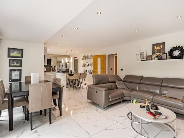 Another shot of the open-plan living area. A porcelain tiled floor and ceiling spotlights add to its stylish appearance.