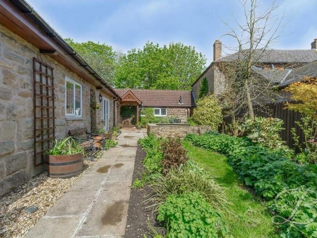 Mature trees and plants add to the appeal of the garden.