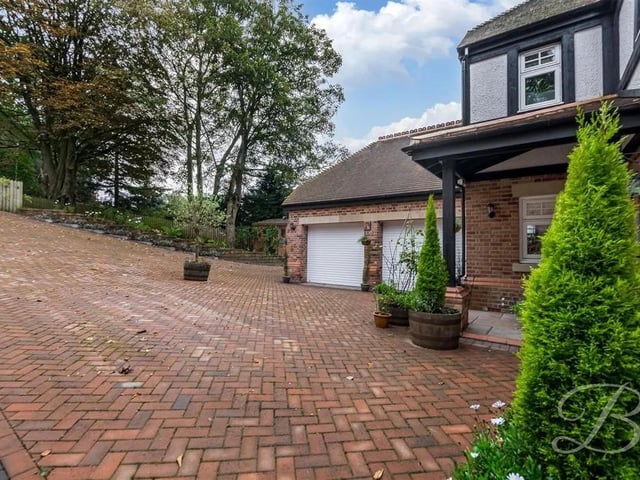 To the front is a generous private driveway and integral double garage, allowing space for ample off-road parking.